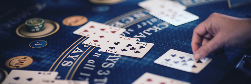 Blackjack gaming table showing cards and chips for card game players.