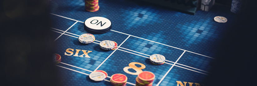 Craps gaming table with dice and chips for players.