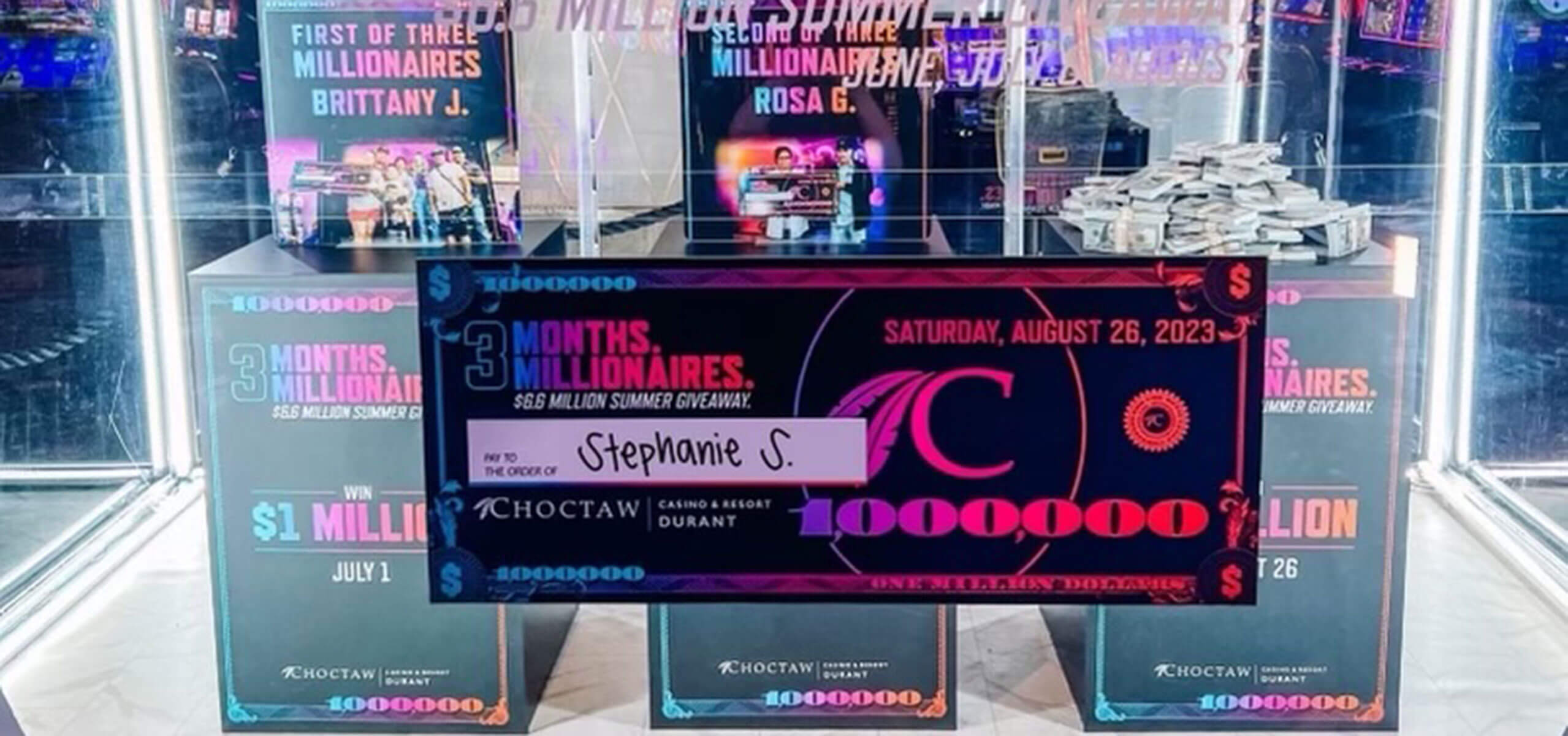August Million Dollar Winner Stephanie S oversized prize check in front of a Choctaw Casinos branded backdrop.