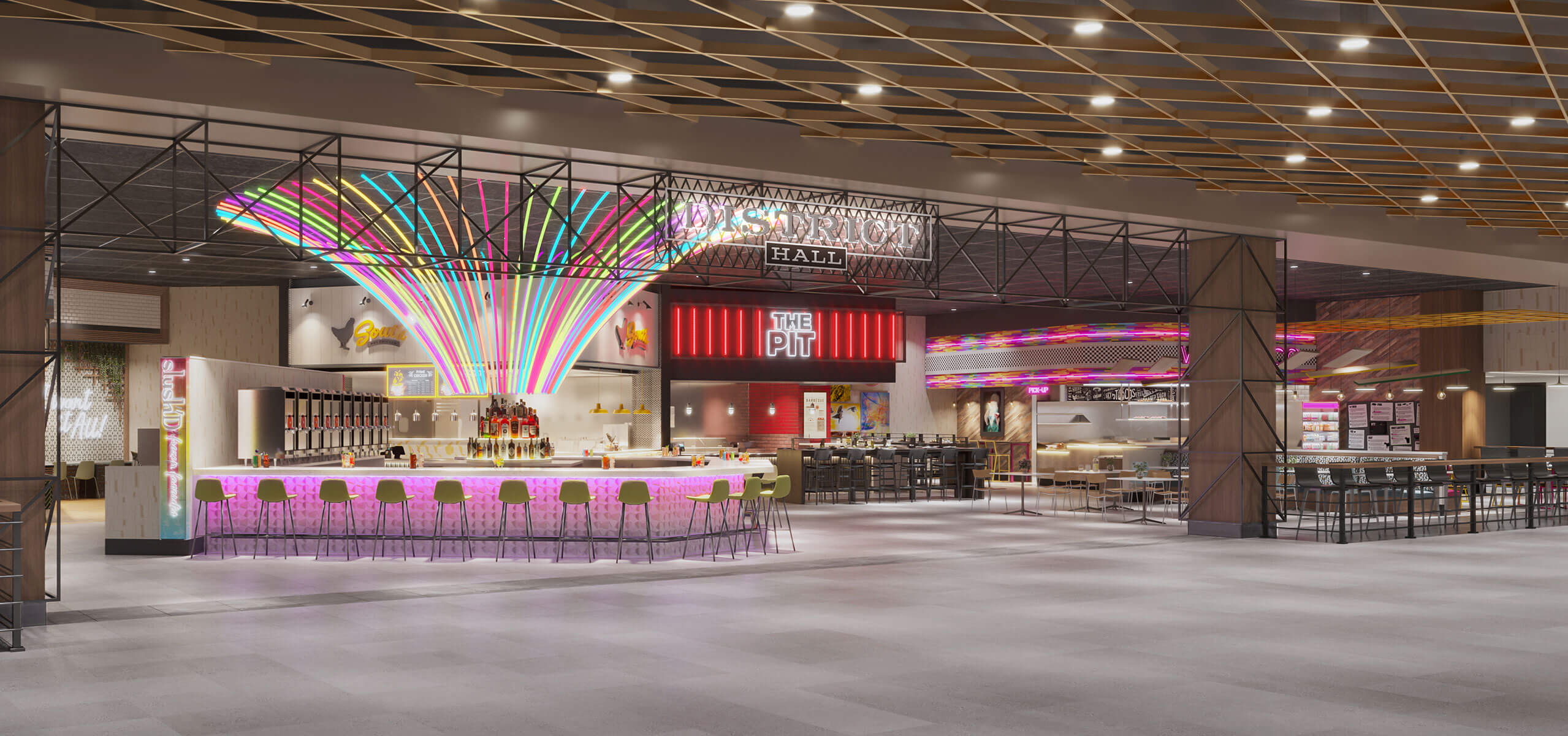 Wide interior view of the District Food Hall at Durant with communal seating and vendor storefronts under bright signage
