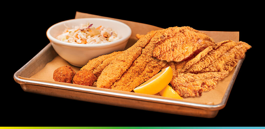 Fried catfish with coleslaw and hush puppies.